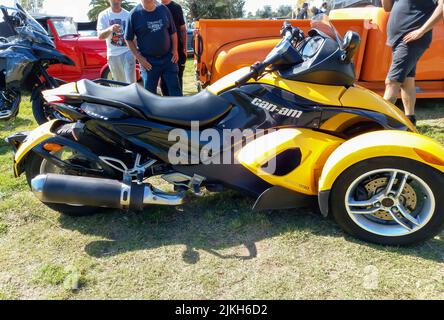 Shot of a black and yellow BRP Can-Am Rotax 990 Spyder roadster trike motorcycle. Classic car show. Copyspace Stock Photo