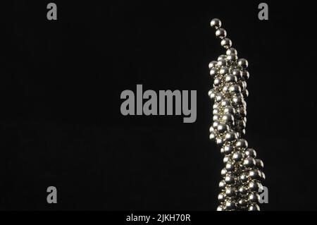Lot of Round Magnetic Spheres on a Black Background Stock Photo