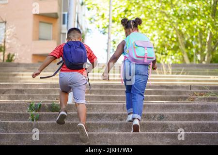 multiethnic kids with backpacks running back to school. Back to school concept. Multiethnic children group Stock Photo