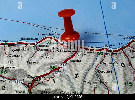 A closeup of a red pin on a map as a concept of traveling destination Stock Photo