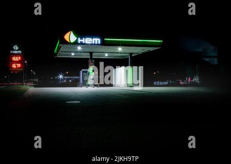 An illuminated Hem gas Station at night Stock Photo