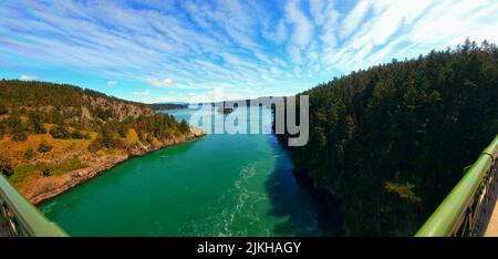 A view of a forest with a lake from the bridge of Deception Pass in Washington State Stock Photo