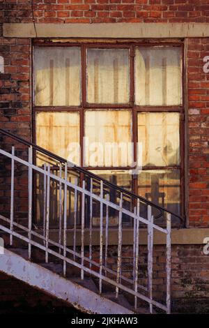 A view of an iron rusty stairs of an old house Stock Photo