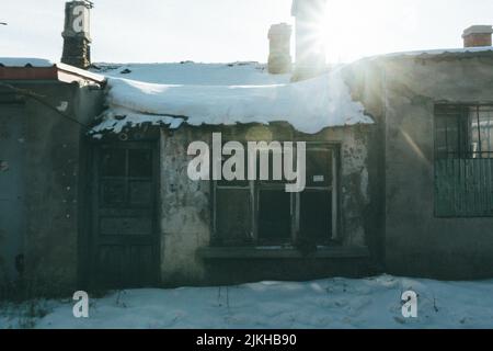 An Abandoned farm house in winter covered with ice Stock Photo