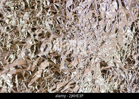 A bright shiny crumpled foil paper texture Stock Photo
