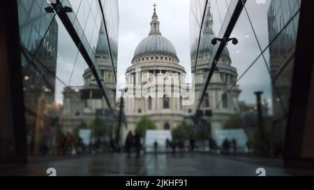 A blurred view of people walking in front of St. Paul's Cathedral in London, glasses are reflected in the foreground Stock Photo