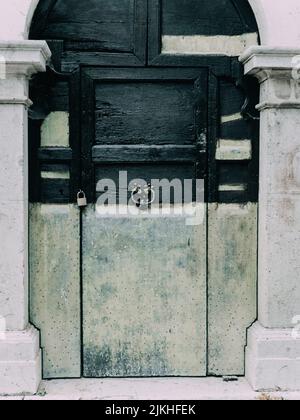 Front of abandoned house with blue door Stock Photo