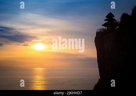 A mesmerizing sunset view over the sea on a sunny evening in summer in Bali Stock Photo