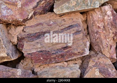 A wall made up of large red boulders. Stock Photo
