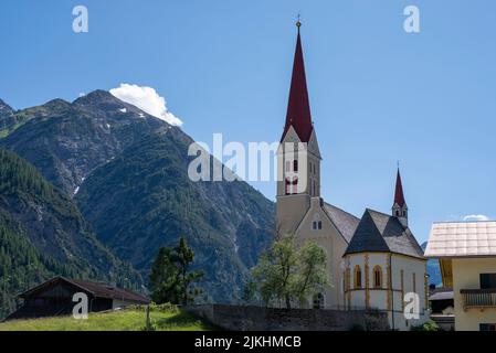 Church of Our Lady of the Assumption, Lechtal Alps, long-distance hiking trail E5, Holzgau, Tyrol, Austria Stock Photo