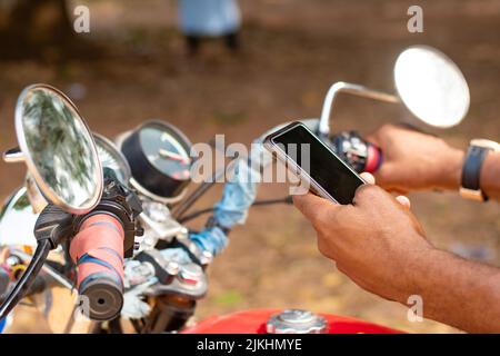 african bike rider using his phone Stock Photo