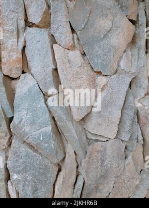 A full-frame shot of a wall texture of elongated colored stones Stock Photo