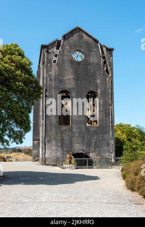 Old tall industrial building at Waihi gold mine in New Zealand Stock Photo