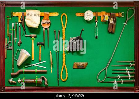 Instruments and hand tools on a green business board with wooden frame Stock Photo