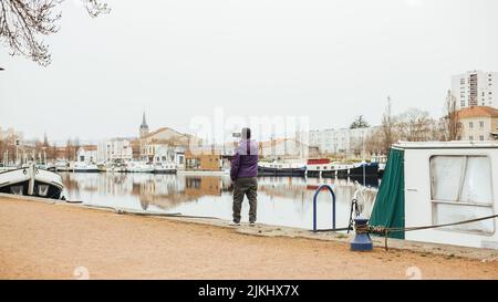 handsome Latin man in port taking picture with his mobile Stock Photo