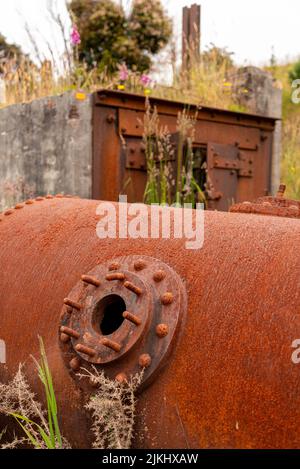 Remains in the landscape of an old mining factory in the ghost town of Waiuta, South Island of New Zealand Stock Photo