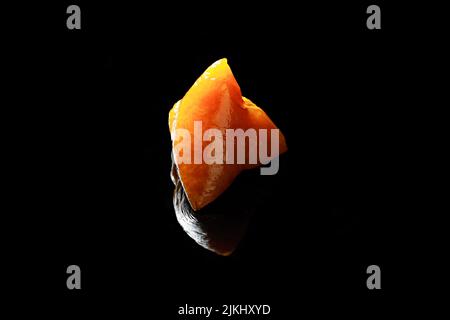 A closeup shot of cooked Zongzi traditional Chinese food isolated with black background Stock Photo