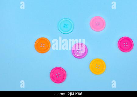 A closeup shot of colorful buttons isolated on the blue background Stock Photo