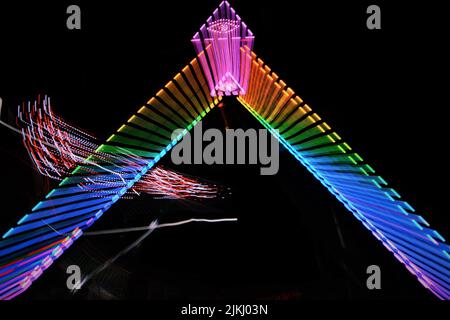 A collection of rides at a county fair taken at night time. Stock Photo