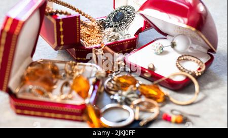 Old red boxes full of jewelry. Treasure chest, close up Stock Photo