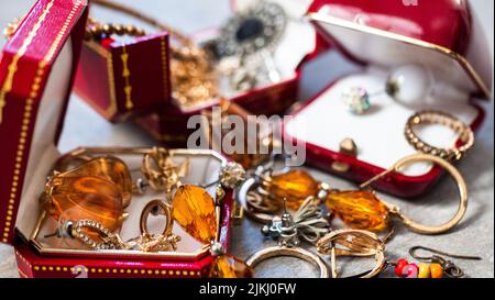 Old red boxes full of jewelry. Treasure chest, close up Stock Photo