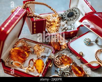 Old red boxes full of jewelry. Treasure chest, close up Stock Photo