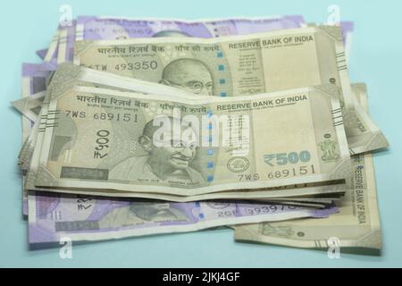 The Indian currency -  500 rupee notes and 100 rupee notes on the blue background Stock Photo