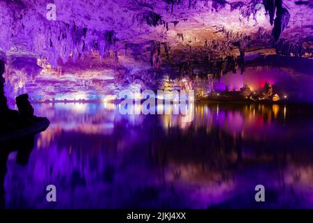 A scenic inside view of the Shuanghedong Caves with colorful lights, Wenquan, Suiyang County, Guizhou Province, China Stock Photo