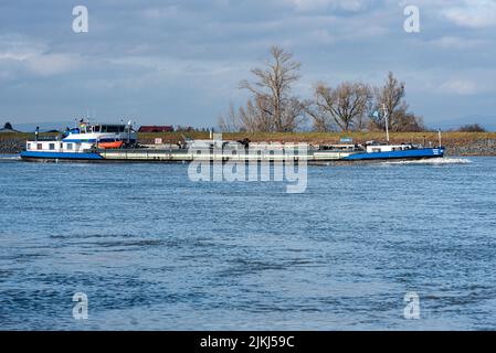 A beautiful shot of the Cargo ships on the River Rhine near Oppenheim in bright sunlight, Germany Stock Photo