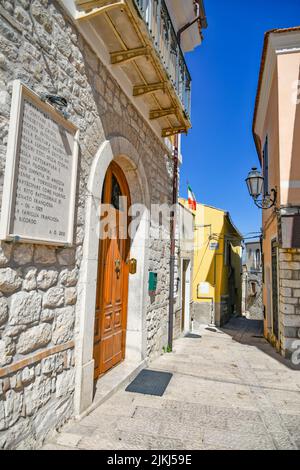 A vertical shot of a narrow alley between medieval stone buildings in Torrecuso, Italy Stock Photo