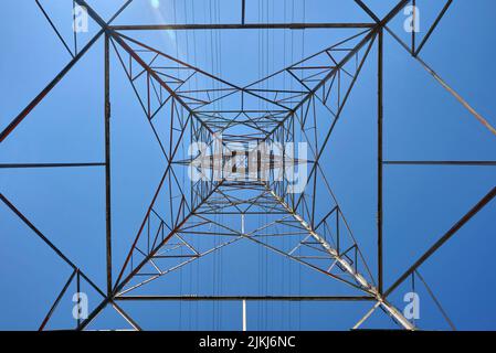 A Transmission tower view from below looking straight up against the blue sky in Ontario, Canada Stock Photo