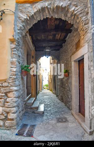 A vertical shot of a narrow street among the old stone houses of Taurasi, a medieval town in Avellino province, Italy Stock Photo
