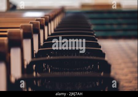 A row of wooden church pews Stock Photo