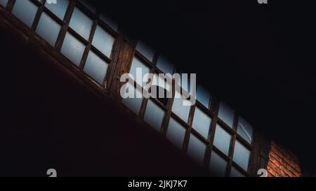 An old building close-up, broken glass in the panel window. Stock Photo