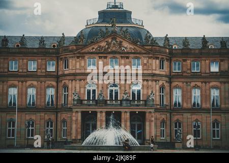 A beautiful shot of The New Palace (Neues Schloss) with a fountain in front of the building Stock Photo