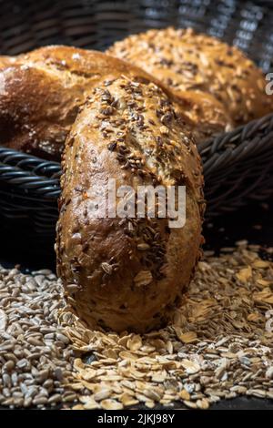 A vertical closeup shot of Multigrain bread in an around a basket Stock Photo