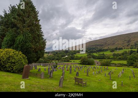 Dent, Cumbria, England, UK - 12 August 2018: Cemetery at the Saint Andrew Church, active Anglican parish church. The church contains Norman architectu Stock Photo