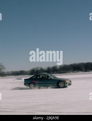 A vintage BMW drifting on ice and snow in Juneau, Alaska Stock Photo