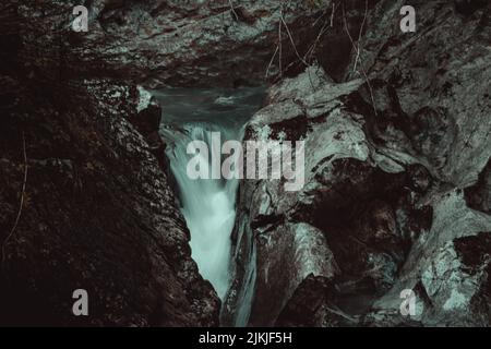 A view of the beautiful small waterfall flowing through the stones in Austria Stock Photo