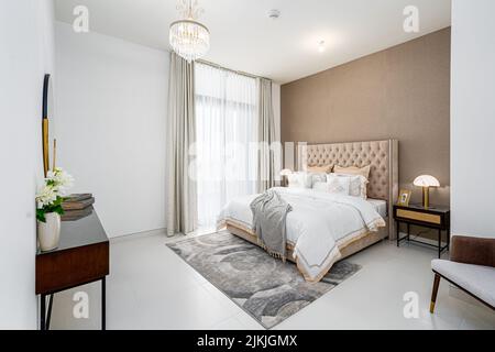 The modern apartment bedroom interior design with a brown bed and small carpet Stock Photo
