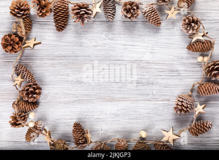 The frame of pine cones on a wooden background with copy space Stock Photo