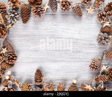 The frame of pine cones on a wooden background with copy space Stock Photo