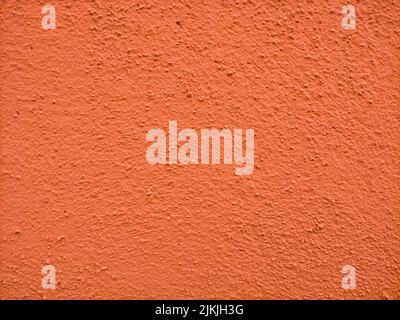 A orange painted stone wall texture with copy space Stock Photo