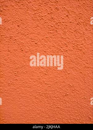 A orange painted stone wall texture with copy space Stock Photo