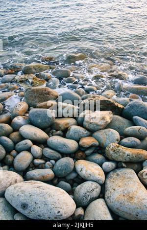 A vertical shot of pebbles on a sea Stock Photo