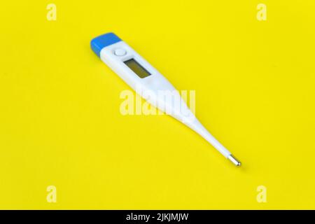 thermometer isolated on yellow background Stock Photo