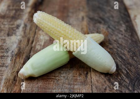 baby corn on a wooden background Stock Photo