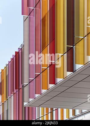 Exterior facade, partially wrapped in colourful glass. Dorothy Crowfoot Hodgkin Building, Oxford, United Kingdom. Architect: Hawkins Brown Architects Stock Photo