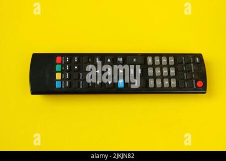 tv remote isolated on yellow background Stock Photo