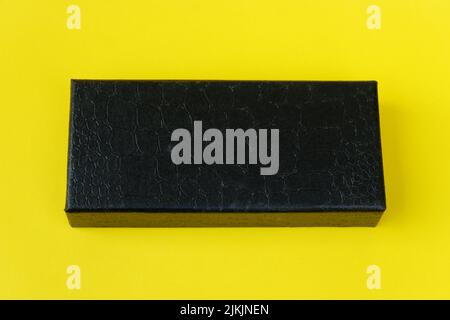 black cardboard isolated on a yellow background Stock Photo